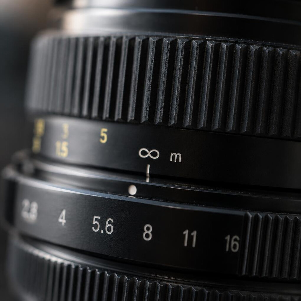 Close-up of a camera lens and focus ring