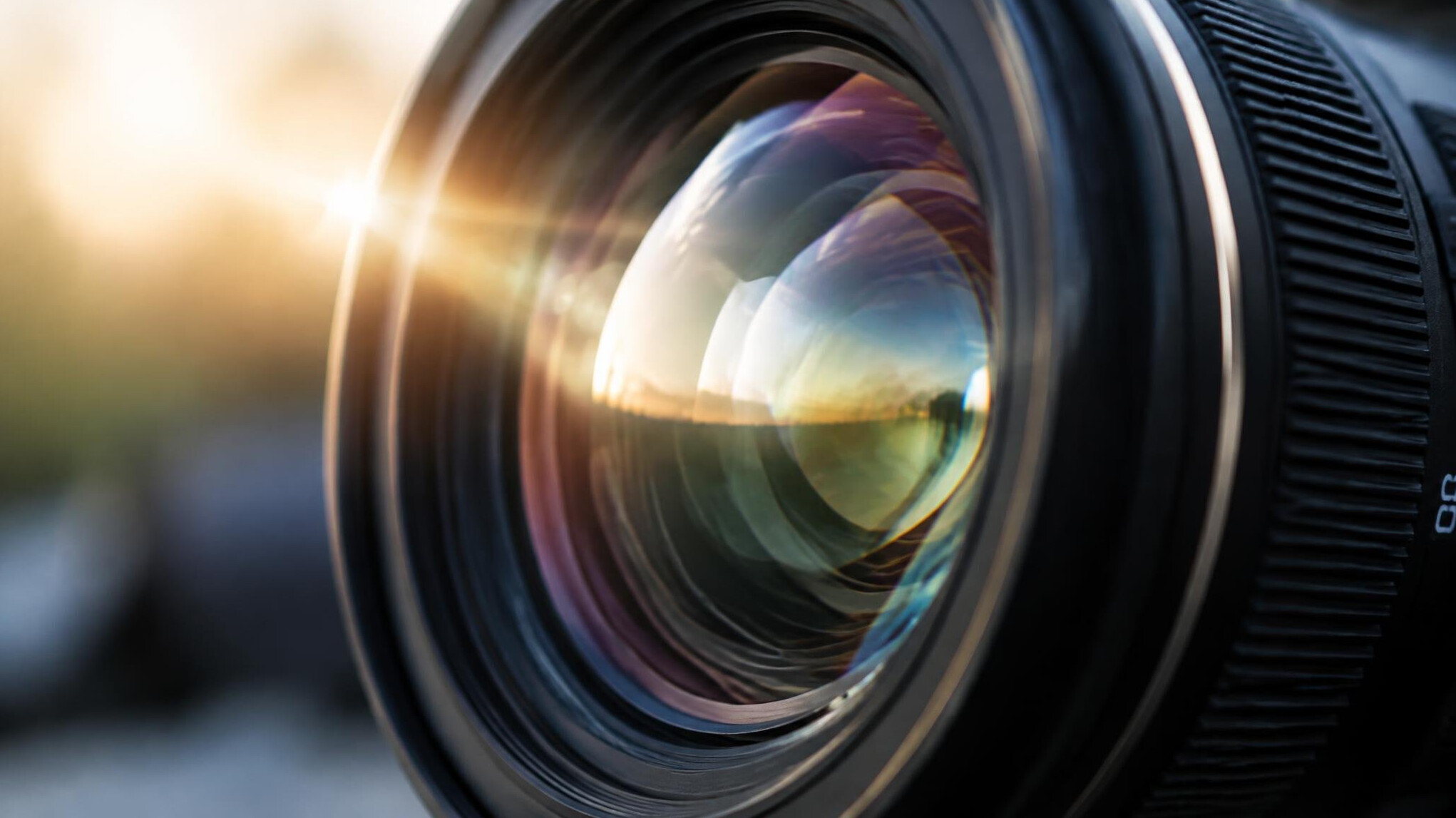 Close-up of a camera lens with light flare